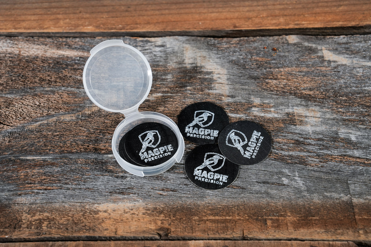 10-pack of Magpie Suppressor Seals shown loose and in the included travel case