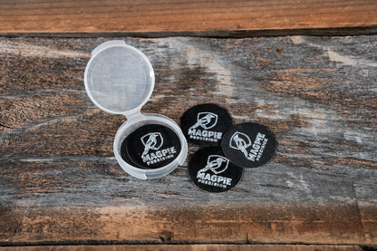 10-pack of Magpie Suppressor Seals shown loose and in the included travel case